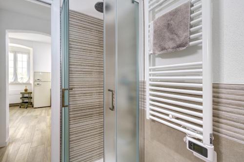a bathroom with a shower with a sliding glass door at Il Timone e L'Ulivo in Moneglia