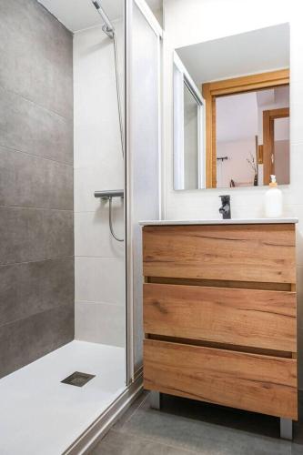 a bathroom with a shower and a sink and a mirror at Relax en Pirineo l Vistas l Wifi l Balcón in Panticosa