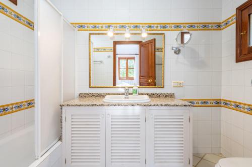 a bathroom with a sink and a mirror at Finca Binifarda by Mallorca House Rent in Felanitx