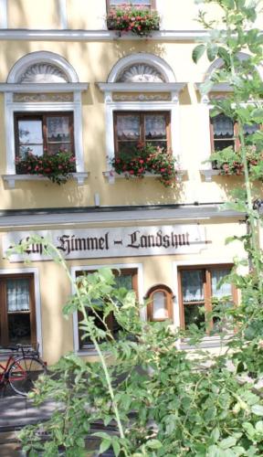 a building with a sign on the side of it at Restaurant-Café-Pension Himmel in Landshut