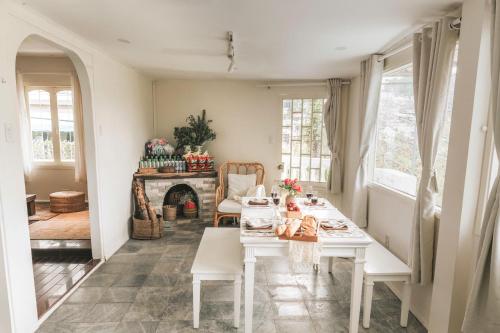 a dining room with a table and a fireplace at StayDalat in Ấp Ða Lợi