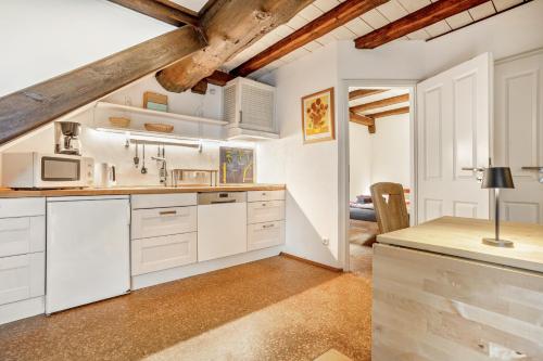 a kitchen with white cabinets and a table with a lamp at Ferienresidenz Villa Kunterbunt in Warstein