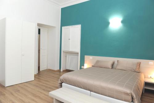 a bedroom with a bed and a blue wall at Torino 1854 Affittacamere in Turin