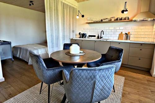 a room with a table and chairs and a kitchen at Storm Villas in Sturmai