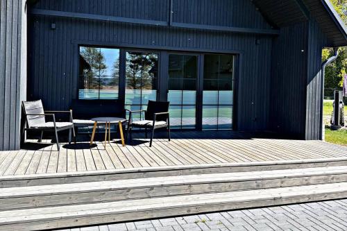 a patio with two chairs and a table on a house at Storm Villas in Sturmai