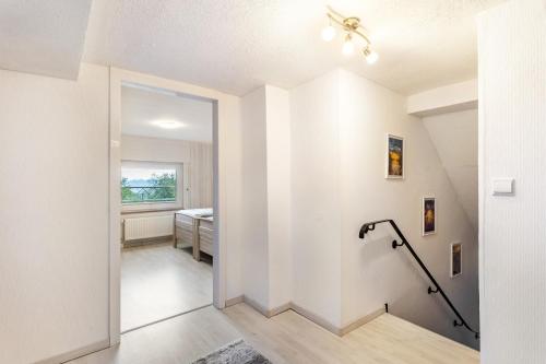 a hallway with white walls and a ceiling at Ferienwohnung Gerke in Warstein