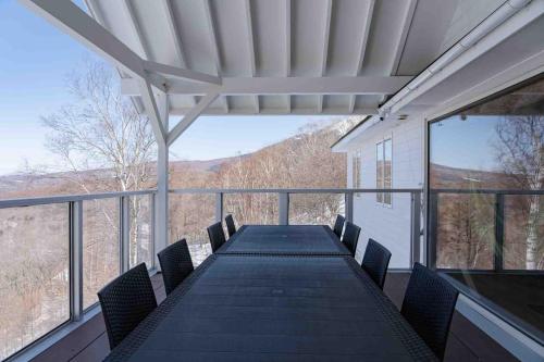 a table and chairs on a balcony with a view at 白樺湖Lake View in Chino
