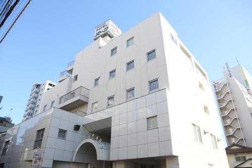 a white building with a dome on top at Kawasaki Hotel Park in Kawasaki