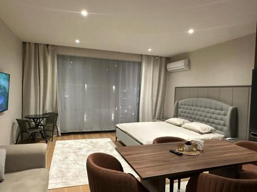 a bedroom with two beds and a table and chairs at Sea Breeze in Baku