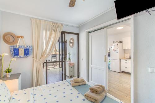 a bedroom with a bed with two towels on it at Rainbow Amadores in Mogán