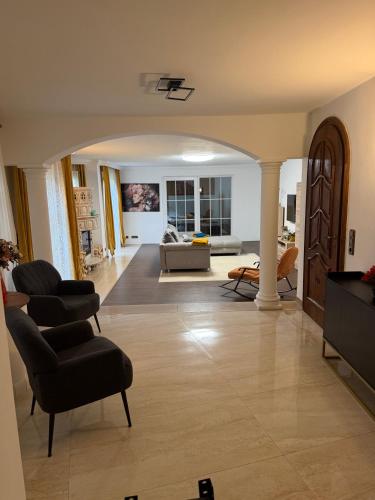 a living room with two chairs and a couch at Romantiksuite Euskirchen in Euskirchen