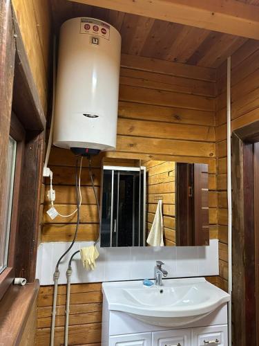 a bathroom with a sink and a mirror at Нур Срубы Сары Ой in Chon-Sary-Oy