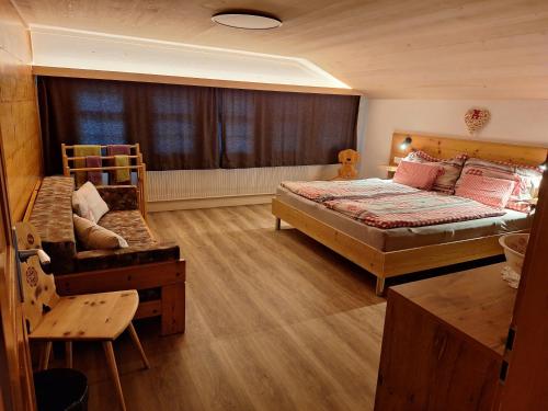 a bedroom with two beds and a couch in it at Mattihus in Sankt Stephan