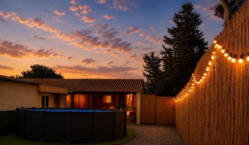 a fence with lights on it in front of a house at Finca Sueño Crea in Lorca