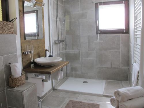a bathroom with a sink and a shower at Chalet Tirolia in Kirchdorf in Tirol