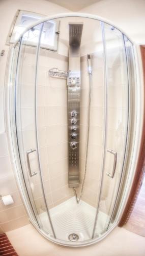 a shower in a room with a glass door at Hotel Krone in Lido di Classe