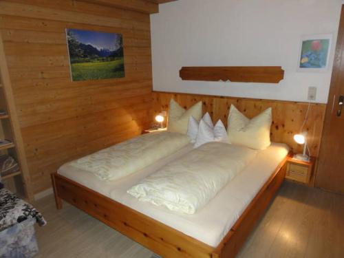 a bedroom with two beds with white pillows at Apart Alpensonne in Zellberg