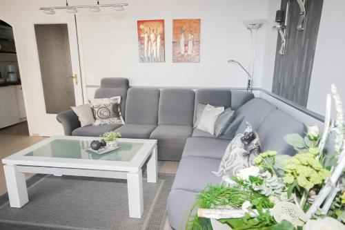 a living room with a couch and a coffee table at Brandungsbad 36 in Grömitz