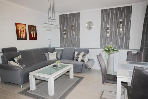 a living room with a couch and a table at Brandungsbad 36 in Grömitz