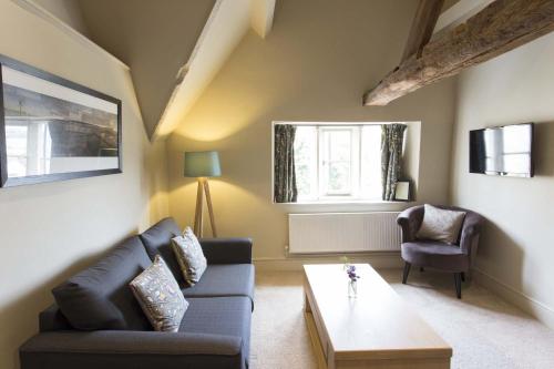 a living room with a couch and a coffee table at The Bell Inn in Stroud