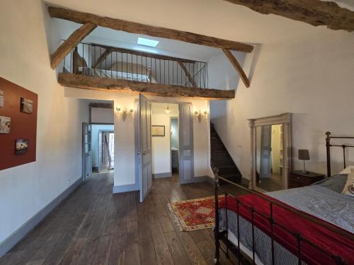 a bedroom with a bed and a wooden floor at Maison centre historique in Lectoure