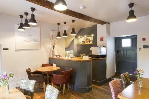 a restaurant with a table and chairs and a kitchen at The Bell Inn in Stroud