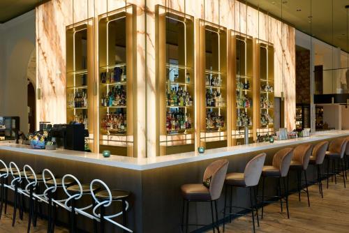 a bar with a row of chairs in a building at The Cloud One Wien-Staatsoper in Vienna