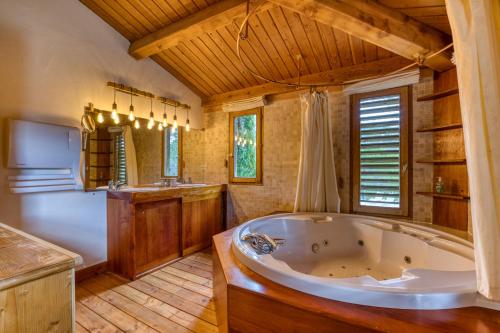 a large bathroom with a tub and a sink at Villa dans Site Exceptionnel in Mourèze
