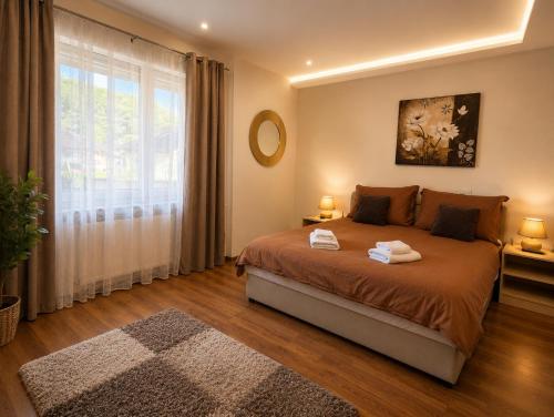 a bedroom with a bed and a large window at Holiday house "Mimoza" 2 massage pools in Otočac