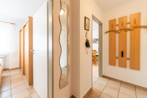 a hallway with a mirror on the wall at Ferienwohnung Bäumer Borkum - Nichtraucher & allergikerfreundlich in Borkum