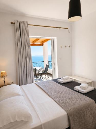 a bedroom with two beds and a view of the ocean at Calypso Private Estate in Xiropigado