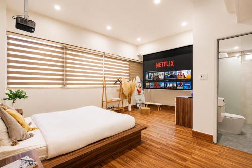 a bedroom with a bed and a flat screen tv at The Morris City Central Boutique in Da Lat