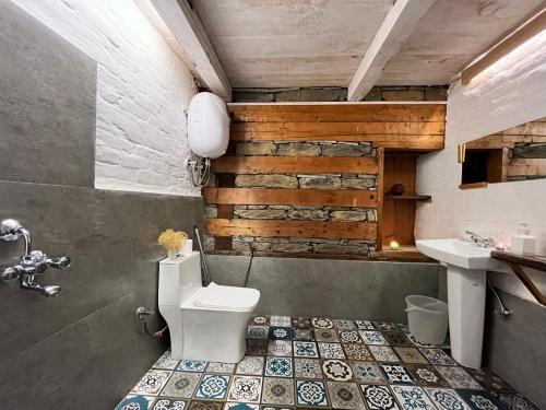 a bathroom with a toilet and a sink at Nirvana Trueliving in Nagar