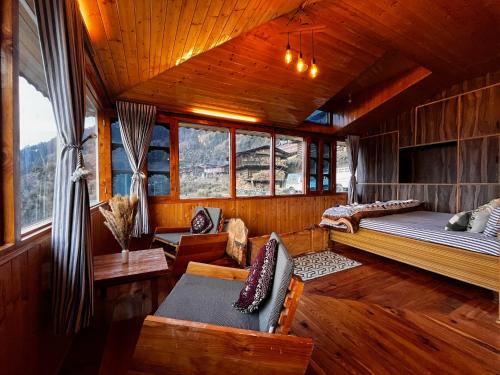 a bedroom with a bed and a couch in a room at Nirvana Trueliving in Nagar