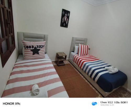 zwei Betten, die in einem Zimmer nebeneinander stehen in der Unterkunft PalmRest in Marrakesch