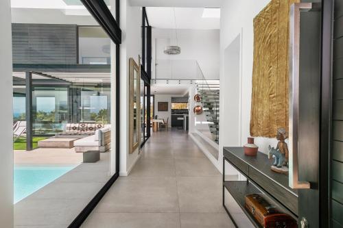 a hallway of a house with a swimming pool at La Villa at Pezula in Knysna