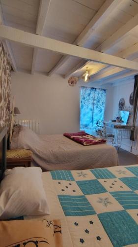 a bedroom with two beds and a table in a room at Casa Isabel in Póvoa dos Mosqueiros
