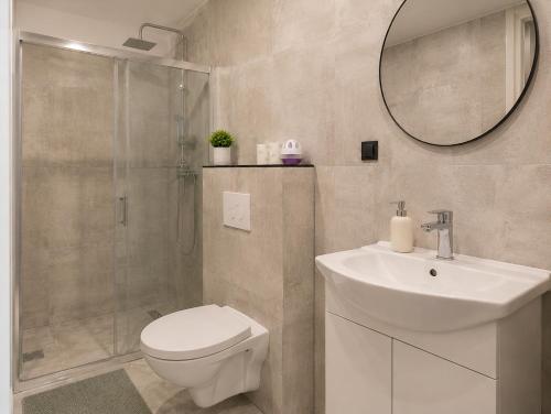a bathroom with a toilet and a sink and a shower at Powidz Work & Stay in Powidz