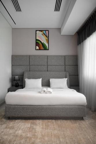 a bedroom with a large bed with a headboard at 108 Opebi Executive Apartments in Lagos
