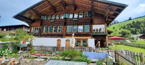 a large wooden house with a fence in front of it at Mattihus in Sankt Stephan