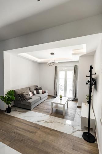 a living room with a couch and a table at Exclusive suite in Hersonissos