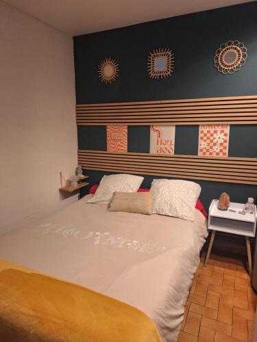 a bedroom with a bed and a wall with clocks at petit cocon in Toulon
