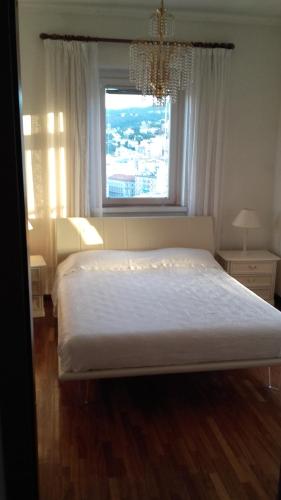 a bedroom with a large bed and a window at La Finestra Sul Mare in Trieste