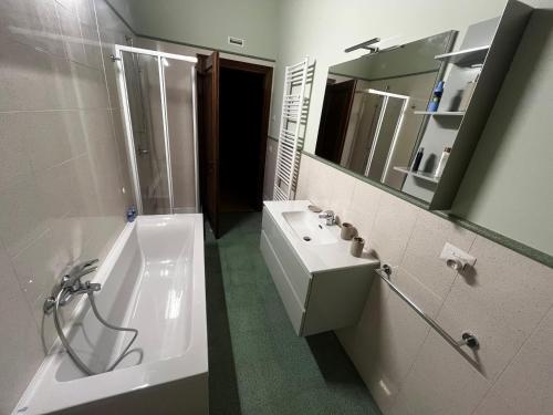 a bathroom with a tub and a sink and a mirror at Antico Granaio di LEO Via Antonia 60 in Ponte Pattoli
