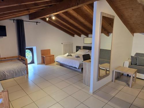 a bedroom with a bed and a couch at La Locanda del Gusto in Cadro