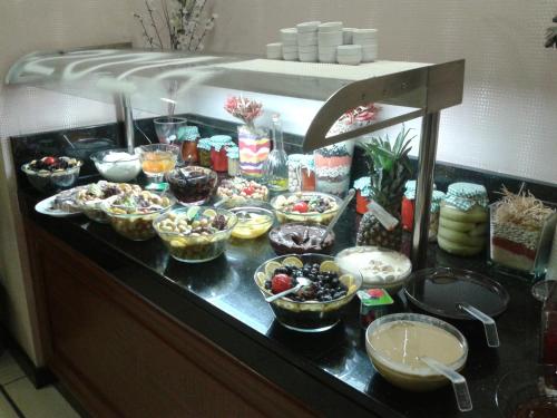 a buffet with many bowls of food on a counter at Tugcu Hotel Select in Bursa
