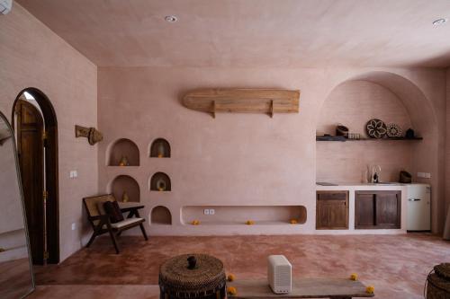 a living room with a table and a kitchen at Le Bohémien Suites Cabana in Dalung