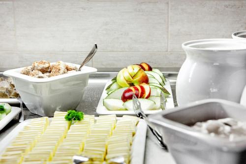 a table topped with plates of food on a counter at Hotel Wilna in Erfurt