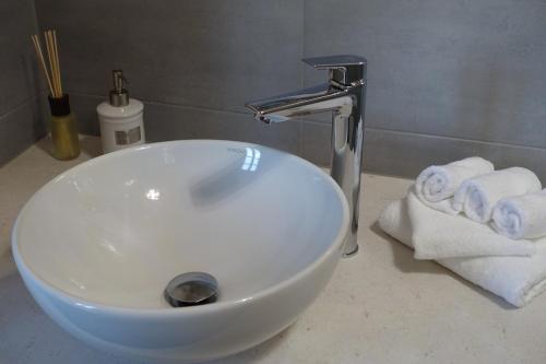 a white bathroom sink with towels on a counter at Rittergut Rottewitz in Meißen