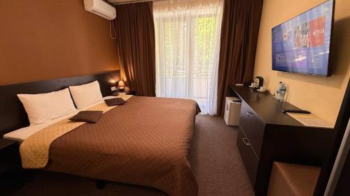 a hotel room with a bed and a large window at EVEREST Готель in Poltava